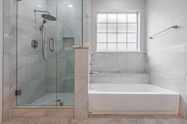 full bath featuring a garden tub and a shower stall