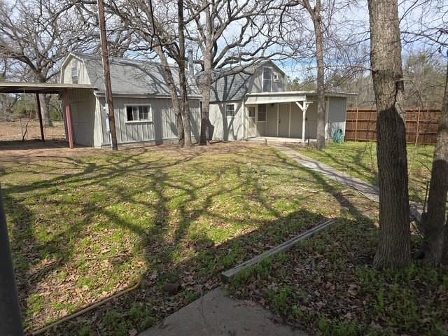 view of yard featuring a carport and fence