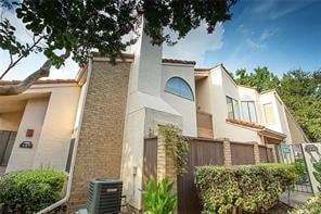 view of home's exterior with fence and cooling unit