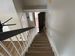 stairs featuring wood finished floors