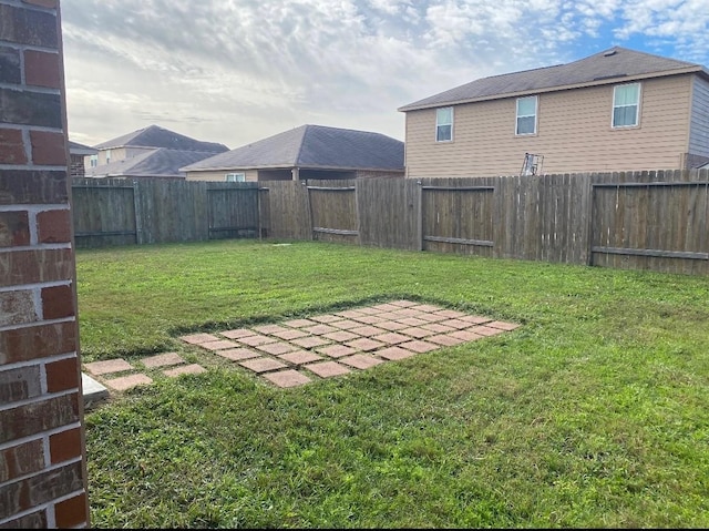 view of yard featuring a patio area and a fenced backyard