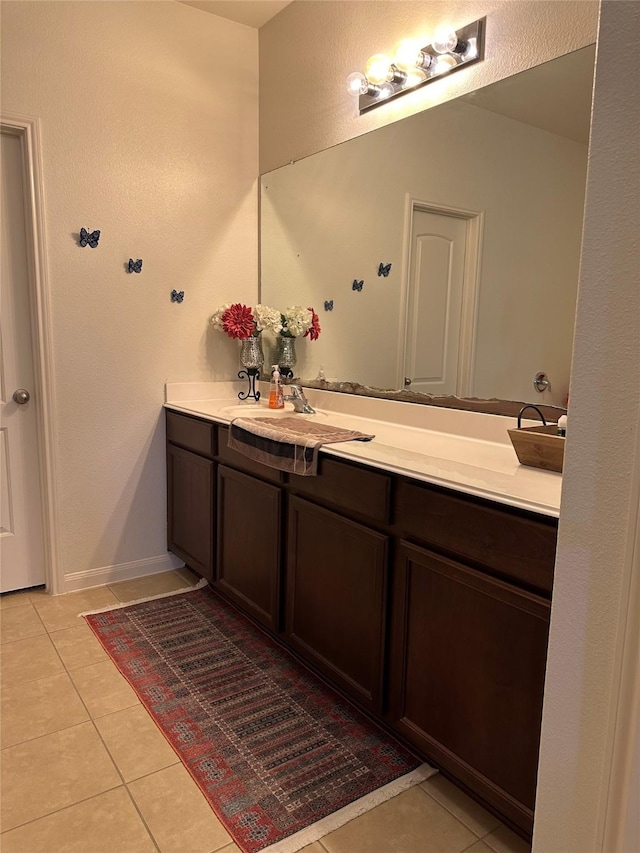 bathroom with tile patterned flooring and vanity