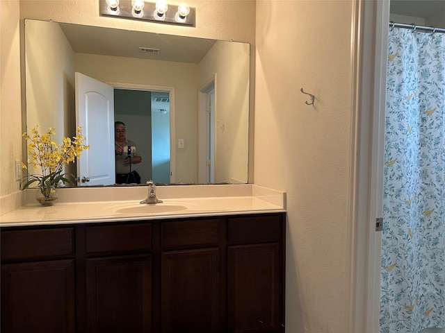 bathroom featuring vanity and visible vents