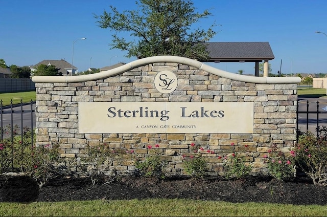 community sign featuring fence