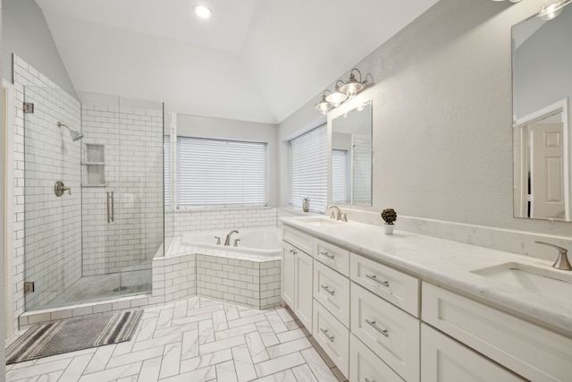 full bathroom with a stall shower, vaulted ceiling, a garden tub, and a sink