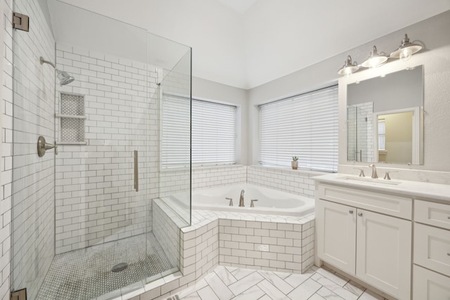 bathroom featuring tile patterned flooring, a garden tub, a shower stall, and vanity