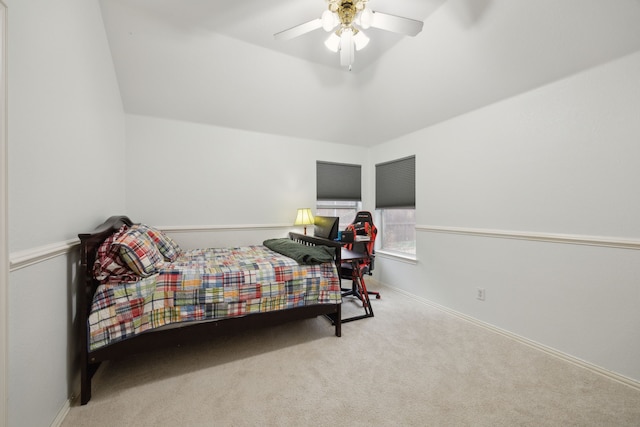 bedroom with a ceiling fan, carpet, lofted ceiling, and baseboards