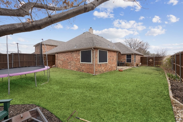 view of yard featuring a fenced backyard and a trampoline