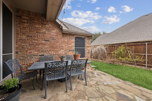 view of patio / terrace with outdoor dining space and fence