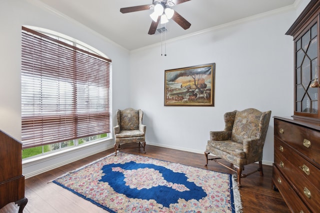 sitting room featuring visible vents, baseboards, a ceiling fan, wood finished floors, and crown molding