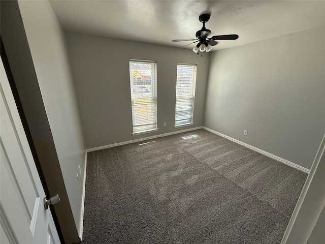 empty room featuring carpet flooring, ceiling fan, and baseboards