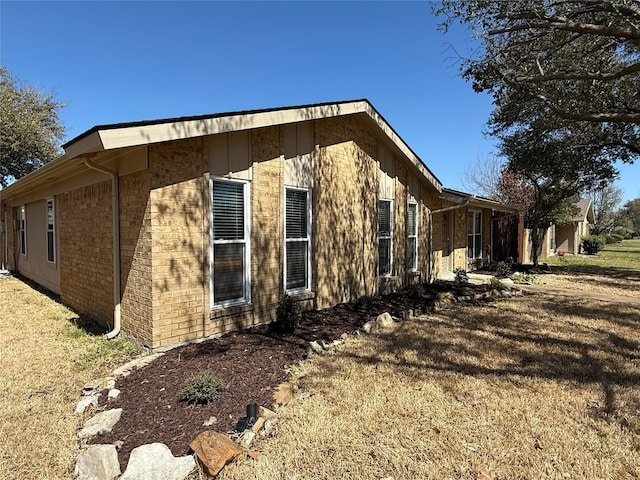 view of side of home with brick siding