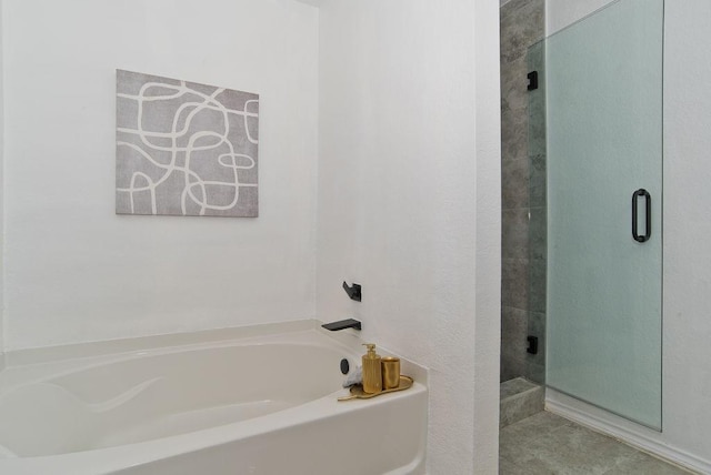 bathroom with tile patterned flooring, a shower stall, and a bath