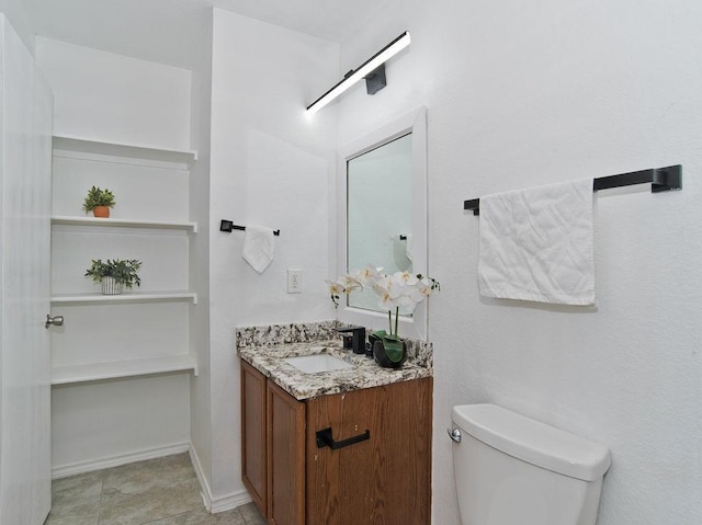 half bath featuring toilet, baseboards, and vanity