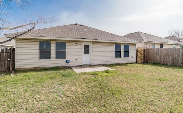 back of house with a shingled roof, a patio area, a fenced backyard, and a yard