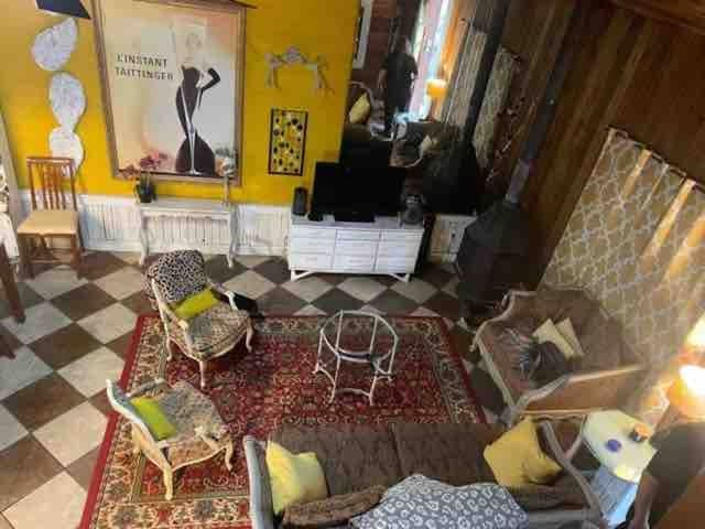 living room with a wainscoted wall and tile patterned floors