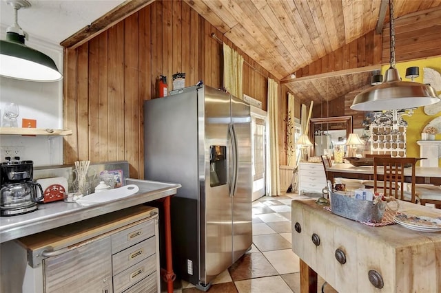 kitchen featuring light tile patterned floors, stainless steel fridge, wooden walls, lofted ceiling, and wooden ceiling