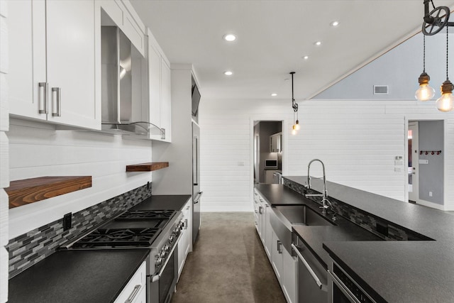 kitchen with high end appliances, dark countertops, and a sink