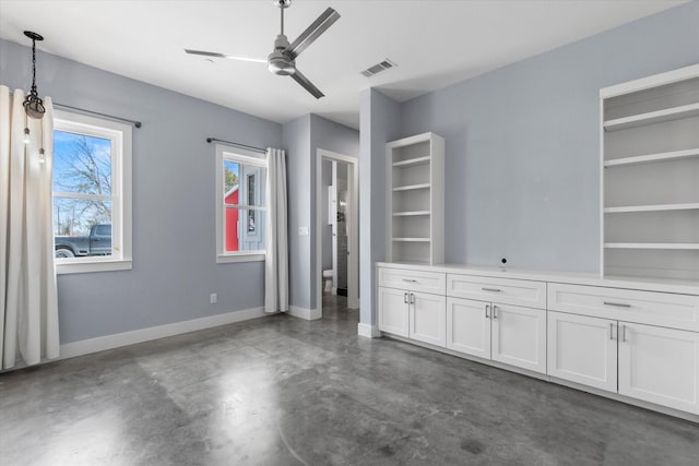 interior space featuring visible vents, ceiling fan, finished concrete flooring, and baseboards