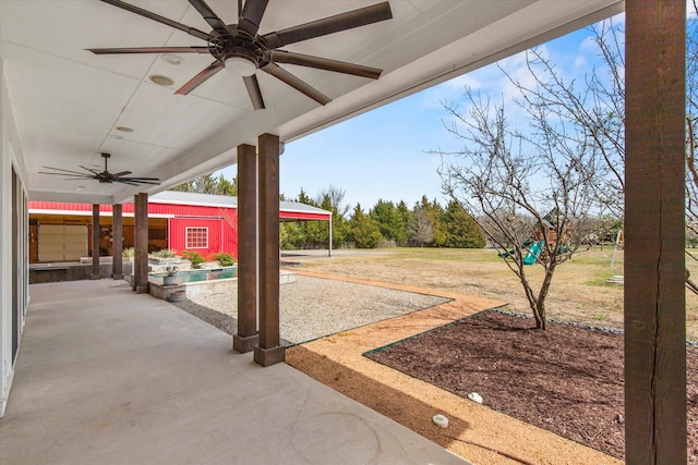 view of patio / terrace featuring a ceiling fan and an outdoor structure