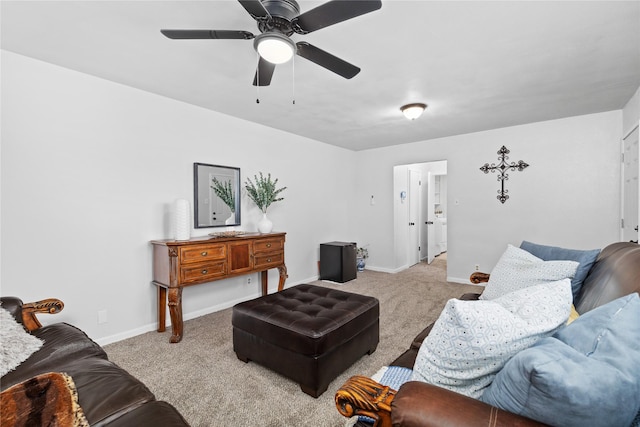 carpeted living room with a ceiling fan and baseboards