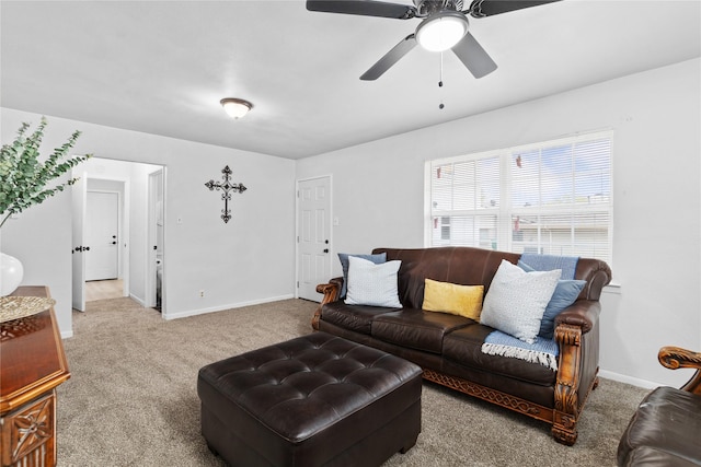 living area with ceiling fan, carpet flooring, and baseboards