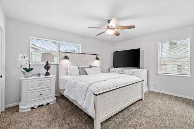 bedroom with a ceiling fan, light colored carpet, and baseboards