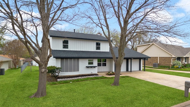 view of front facade with an attached garage, fence, concrete driveway, a chimney, and a front yard