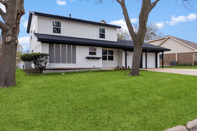 view of front of home featuring concrete driveway, a chimney, an attached garage, central AC, and a front yard