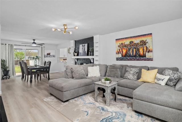 living room with wood finished floors and a notable chandelier