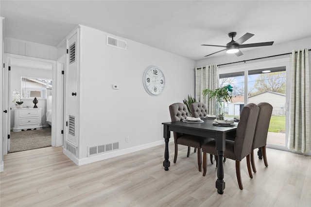 dining area with light wood-style floors, visible vents, ceiling fan, and baseboards