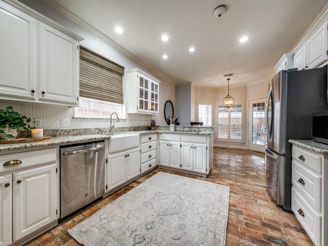 kitchen with white cabinets, appliances with stainless steel finishes, a peninsula, crown molding, and recessed lighting