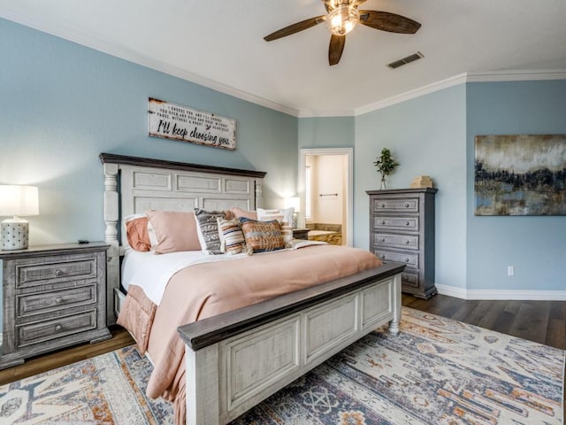 bedroom featuring baseboards, crown molding, visible vents, and wood finished floors