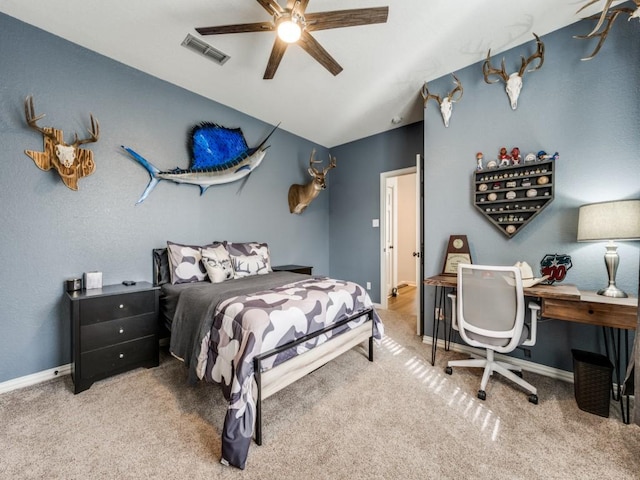 carpeted bedroom with a ceiling fan, lofted ceiling, visible vents, and baseboards