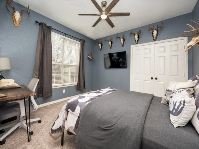 bedroom with ceiling fan, carpet floors, a closet, and baseboards