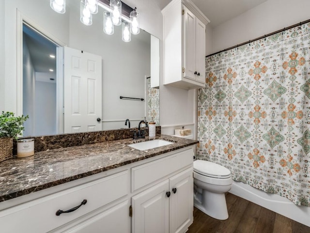 bathroom with vanity, shower / bath combo with shower curtain, wood finished floors, and toilet