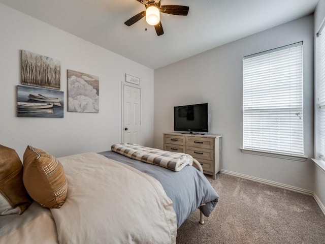 bedroom with light carpet, a ceiling fan, and baseboards