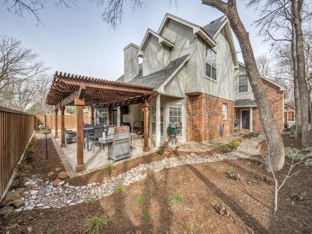 back of property featuring a fenced backyard, brick siding, outdoor lounge area, a pergola, and a patio area