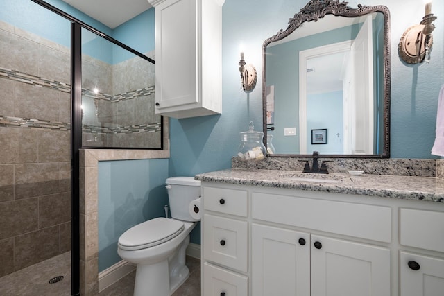 bathroom with a stall shower, vanity, and toilet