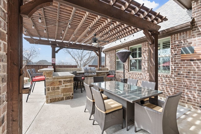 view of patio / terrace with outdoor dining area, outdoor dry bar, area for grilling, fence, and a pergola