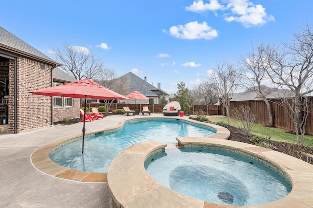 view of swimming pool featuring a patio area, a fenced backyard, and an in ground hot tub