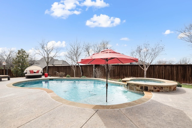 view of swimming pool with a patio area, a fenced backyard, and a pool with connected hot tub