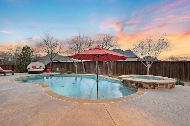 view of pool with a patio area, a fenced backyard, and a pool with connected hot tub