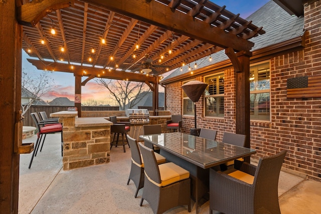 view of patio featuring outdoor dining area, outdoor dry bar, area for grilling, a grill, and a pergola