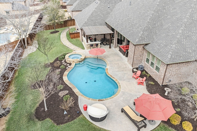 view of pool featuring a pool with connected hot tub, a fenced backyard, a patio, and an outdoor hangout area