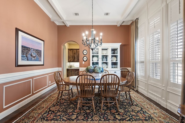 dining area with beam ceiling, visible vents, coffered ceiling, and a notable chandelier