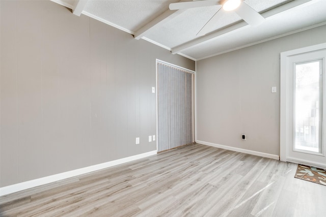 spare room with light wood-style floors, a textured ceiling, baseboards, and a ceiling fan