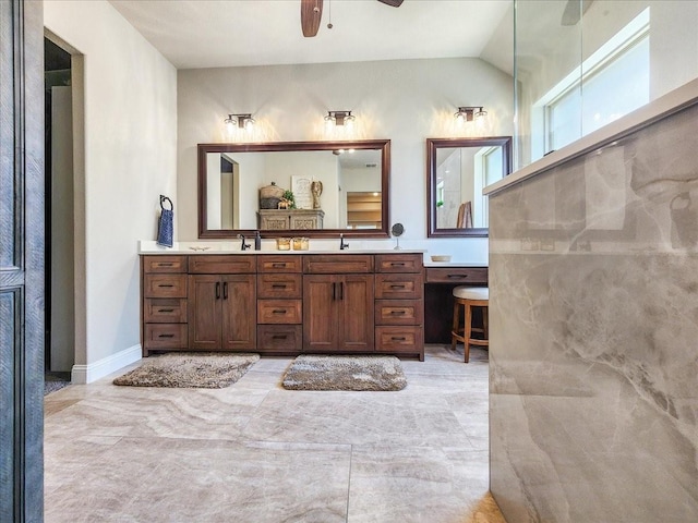 full bath featuring double vanity, a ceiling fan, a sink, and lofted ceiling