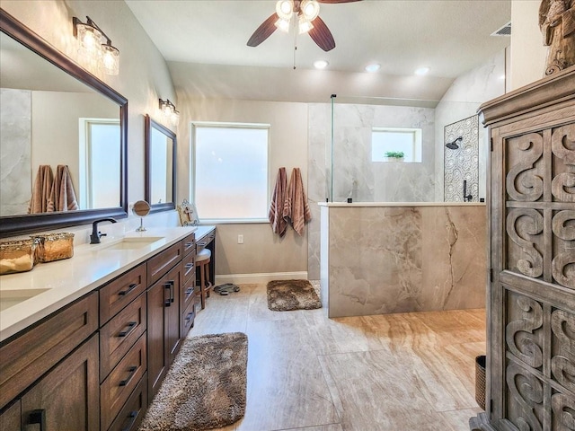 full bath featuring double vanity, visible vents, a sink, a walk in shower, and baseboards