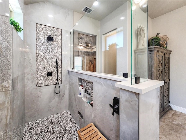 bathroom featuring a walk in shower, visible vents, and baseboards